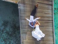 photo-of-bride-and-groom-laying-on-pier-1034356